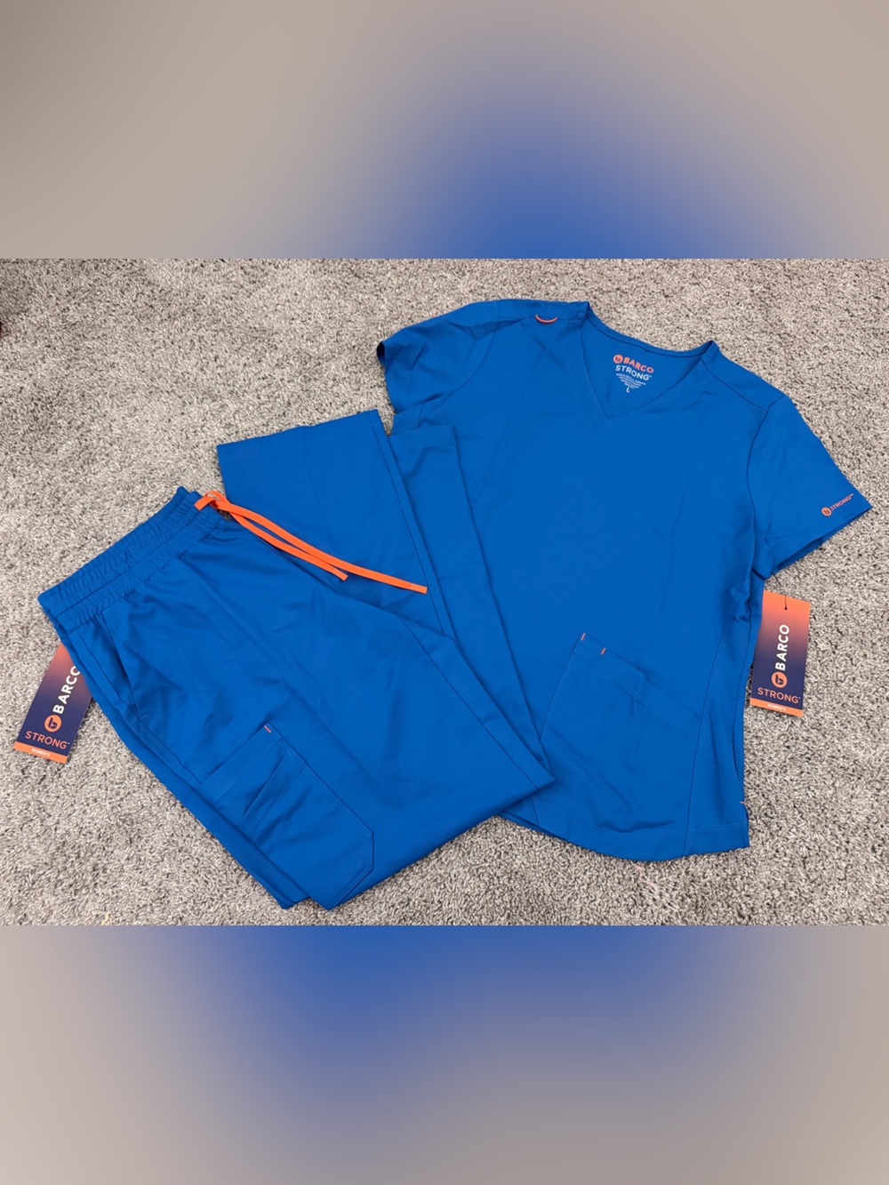 Barco Uniforms Blue V-Neck Scrub Top with Orange Logo